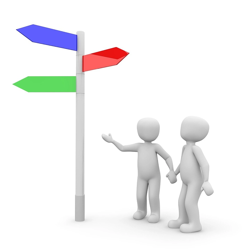 Zwei Männchen stehen vor einem Wegweiser.